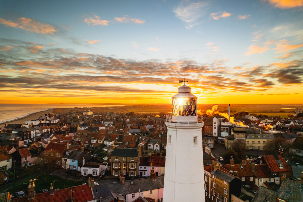 The Southwold lighthouse bathed in dawn sunlight